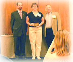 Sharon Miller receives her participation plaque.