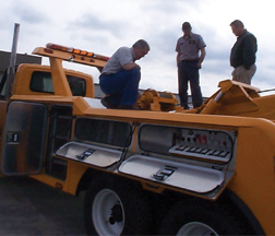 Three men on a wrecker