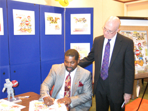 Frank Jones signs a copy of the StopKat Activity Book
