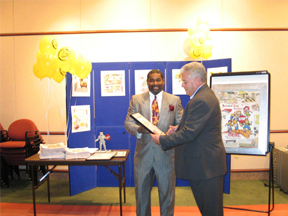 Frank Jones signs a copy of the StopKat Activity Book